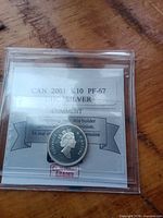 obverse view of 2001 Canadian dime in holder with PF-67 label