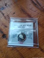 Front of holder showing 1996 CAN ¢10 PF-67 label and coin obverse