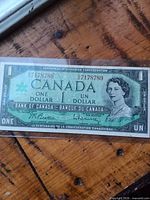 Obverse view showing Queen Elizabeth II, centennial logo, serial number 57178789