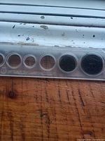 Full view of plastic holder showing eight coin slots