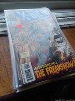 Stacked comics in bags, Shadowman #26 visible