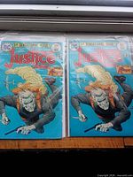 Front view of both bagged Justice Inc. #1 comics