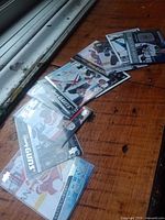 Eight Upper Deck Young Guns rookie cards laid out on wood surface