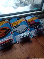 Overview of three Hot Wheels cards in lot