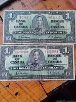 Both $1 notes side by side showing full obverse details