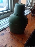 Front view of olive drab plastic canteen