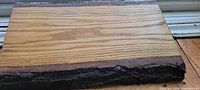Rectangular white oak board showing live edge bark and wood grain
