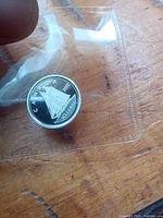 Reverse of 2022 Canadian 10-cent sterling silver coin in sleeve