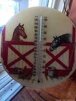 front view of round barn scene thermometer showing full design and scale