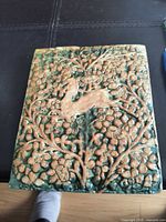 Front of tile showing Persian Antelope relief and glaze