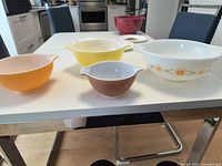 Group shot of all four Pyrex Cinderella nesting mixing bowls