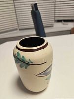 Front view showing painted floral motif and rim band