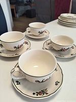 Four cups on saucers showing pattern and size difference