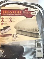 Front of packaged Biddeford Heated Comfort Knit Blanket showing brand, features, queen size