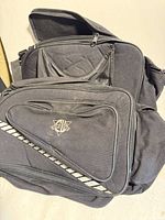 Pair of Cold Wave black saddle bags showing logo and reflective stripe
