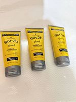Three yellow tubes of got2b Glued Styling Spiking Glue front view