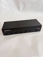 Front angled view showing full device and six selector buttons