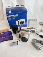 Complete lot with camera, box, manuals, memory card and accessories visible