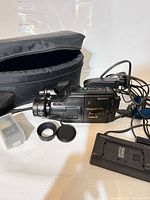 Camcorder with charger, cables, lens accessories, clear box and soft case