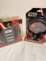 Both boxed Star Wars headphones side by side
