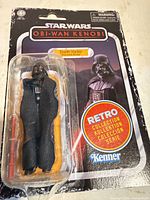 Front view of carded Darth Vader Retro Collection figure with accessory