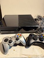 Xbox One console front view with two controllers