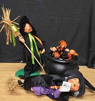 Group shot: standing witch, flying witch, cauldron with small figures