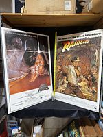 Both mounted posters side by side with measuring tape