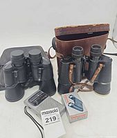Overview showing two binoculars, radio, Debonair box, cases