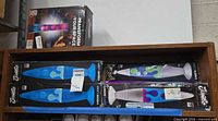 shelf with four boxed lava lamps, three Jambo Liquid Lamp and one other style
