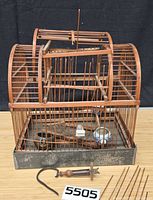 Full view of bamboo birdcage with loose parts and hook assembly