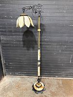 Full view of slag glass floor lamp with lotus shade and decorative column