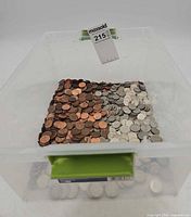 Top view of plastic bin showing large quantity of copper and silver-tone US coins