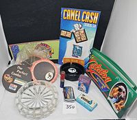 group shot of all items including ashtrays, lighters, catalogs, coasters