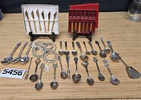 Group shot of all utensils, napkin rings, knife sets and spoons