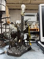 Full view of deer lamp showing socket and tree trunk