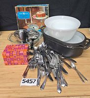 Group shot of all items: Dutch oven, mixing bowls, bundt pan, funnel, index card box, flatware