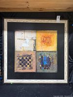 Front view of framed four-panel abstract artwork