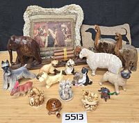 Group shot of all items including pillows, wooden figures, ceramic and resin figurines