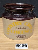 Front view of stoneware crock showing full graphics and color