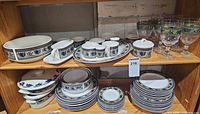 Full view of dinnerware and glassware on shelves