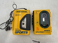 Front view showing both Walkman units and headphones
