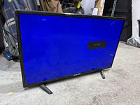 Front view showing powered-on blue screen with on-screen input message