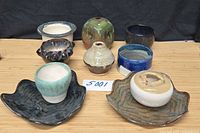 Group shot of all nine pottery pieces on table