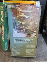 Front of boxed Midwest Gloves & Gear greenhouse showing product image and branding