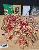 Overview of entire lot of straw ornaments, framed pieces, and bags