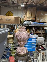 Full view of pink porcelain cherub lamp with harp and bulb