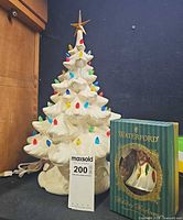 White ceramic Christmas tree with multicoloured bulbs and Waterford ornament box