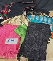 Group shot of all eight scarves and shawls