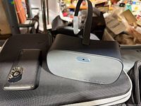 Vision Buddy headset on carrying case with remote
